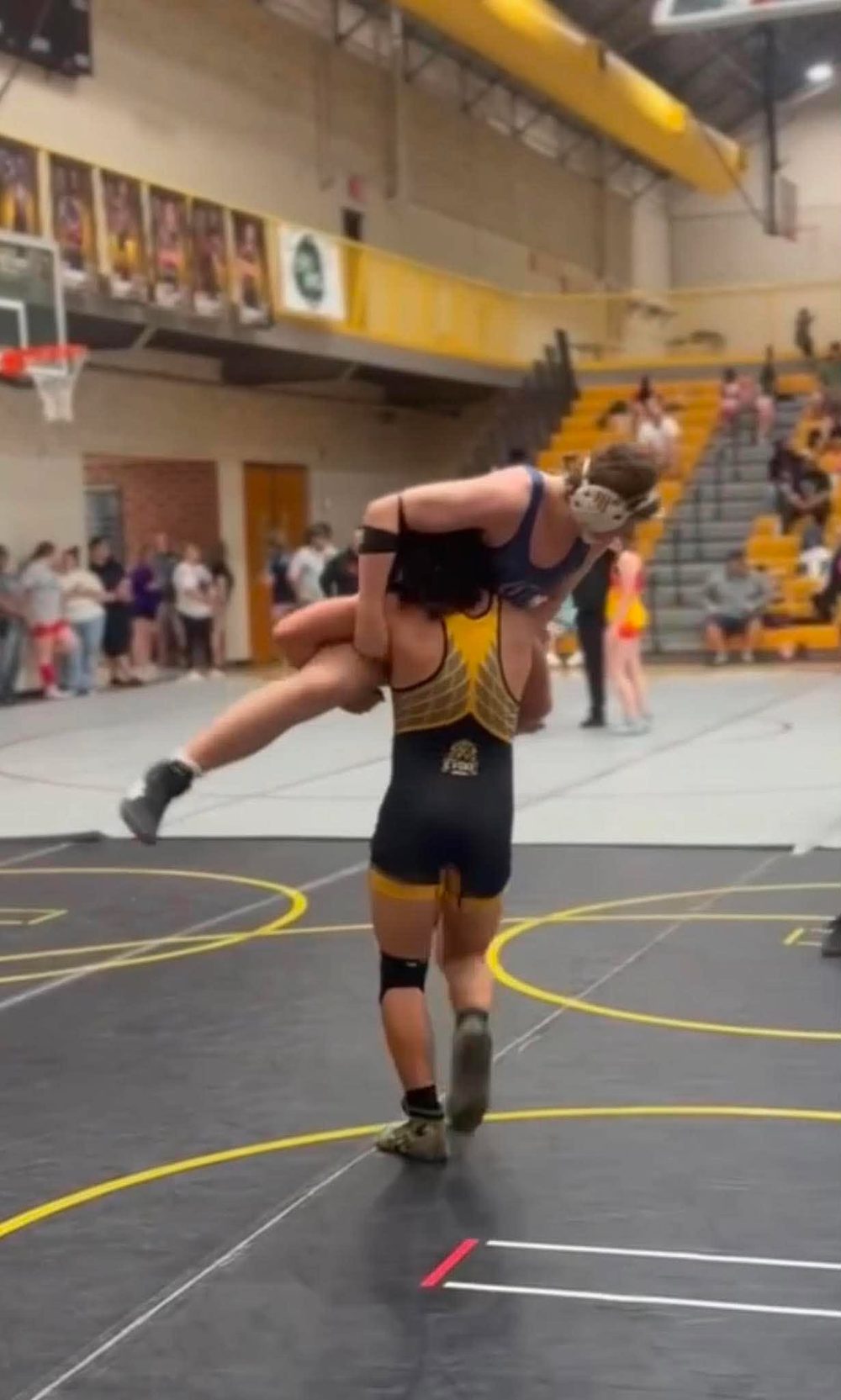 Evoke Warriors wrestler hitting a lift in a tournament match